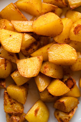 Close up of baking tray with Patatas Bravas, a traditional Spanish tapas dish, potato cubes or wedges roasted, baked or deep fried until tender and cripsy on the outside