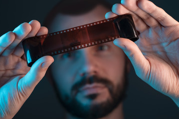 A man checks a film shot after development