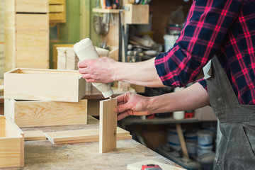 Worker making the wood box. Profession, carpentry and woodwork concept.