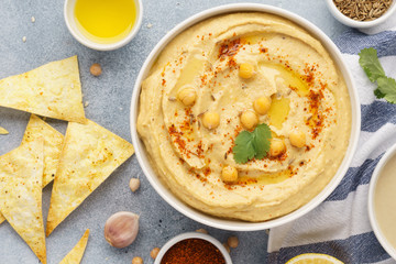 Hummus bowl served with tortilla chips. Middle eastern food.