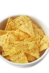 Corn Totillas chips in a bowl isolated on white background. Mexican food also called Nachos