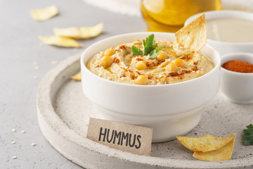 Healthy homemade hummus with olive oil and chips.
