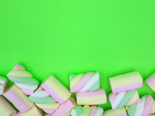 Colorful Marshmallows on green background