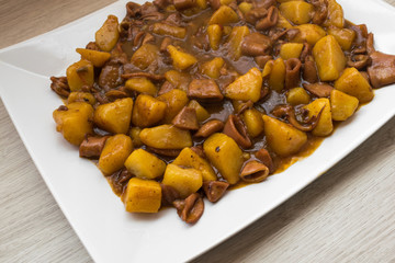 squid stew with potatoes on a white plate