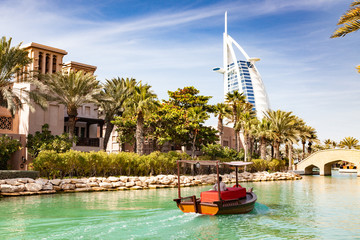 DUBAI, UAE - FEBRUARY, 2018: View on Burj Al Arab, the world only seven stars hotel seen from Madinat Jumeirah, a luxury resort which include hotels and souk spreding across over 40 hectars