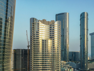 Top aerial view shot of Al Reem island Sun and Sky towers and landmarks in Abu Dhabi city, UAE