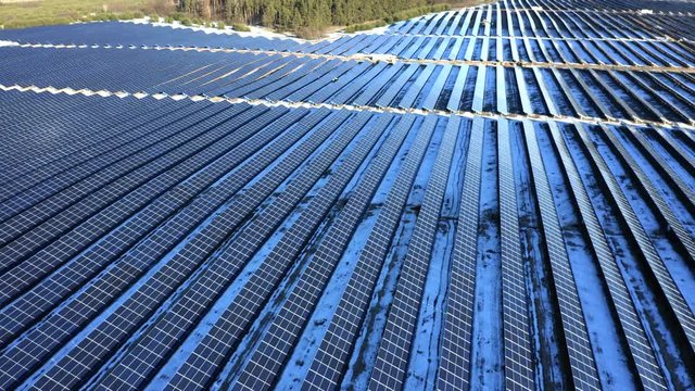 Aerial view of the industrial solar power station (solar electricity plant) on a winter sunny day