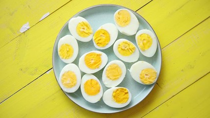 Boiled chicken eggs on a blue ceramic plate. The concept of Easter Holidays - Powered by Adobe