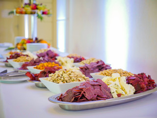 table snacks. meat cheese nuts pistachios