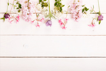 Fototapeta premium Festive flower composition on the white wooden background. Overhead view