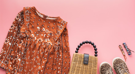 Girls fashion background, brown dress, trendy straw bag, leopard print shoes, bracelets on pink, flat lay, top view, sopy space selective focus