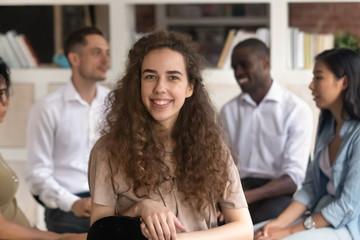 Young female therapist training participant coach posing at group therapy