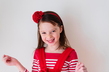 Portrait of young girl wearing red