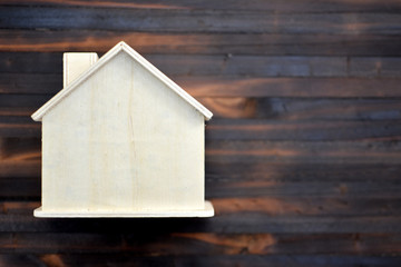 Obraz na płótnie Canvas House model on old wood background , saving for residential .