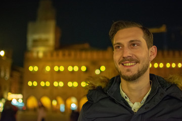 bologna/Italy 18 february 2019 :portrait of man smiling and looks happy enjoying the beautiful but cold night © Giorgio Tzitzi