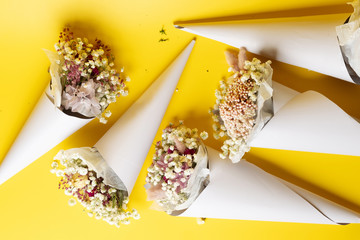 Flowers composition. Frame made of dried flowers on yellow background. conceptual photo of dried flowers 