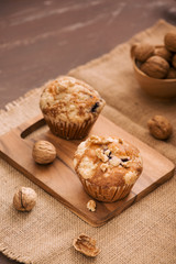 Tasty homemade walnut muffins on table. Sweet pastries