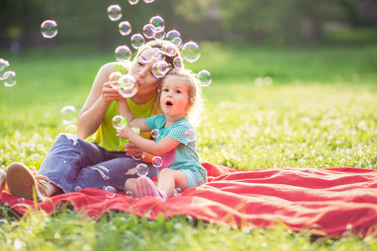 lovely mother with their daughter having fun .