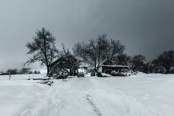 Wooden houses in Carpathian Mountains in winter at night