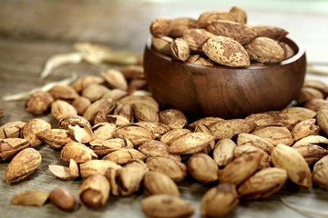 roasted almond on wooden bowl