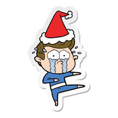 sticker cartoon of a crying dancer wearing santa hat