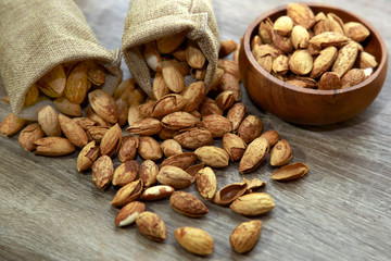 roasted almond on wooden bowl and burlap bags