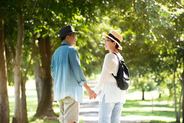 Image of happy romantic Asian senior couple outdoor in park