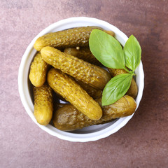 Pickles. Bowl of pickled gherkins cucumber with copy space. Cornichons.