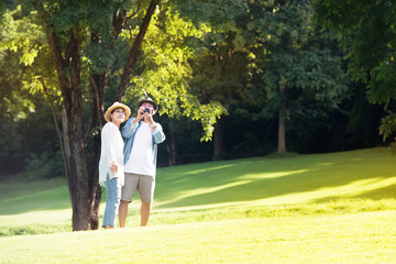 Image of happy romantic Asian senior couple outdoor in park