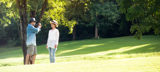 Image of happy romantic Asian senior couple outdoor in park