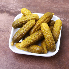 Pickles. Bowl of pickled gherkins cucumber with copy space. Cornichons.