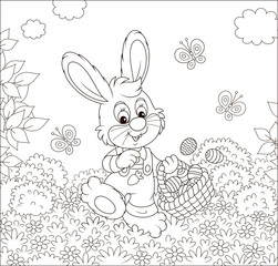 Friendly smiling Easter Bunny with a basket of painted eggs walking among flowers on sunny spring day, black and white vector illustration in a cartoon style for a coloring book