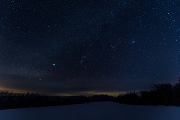 Fototapeta na wymiar starry dark sky in carpathian mountains at night in winter