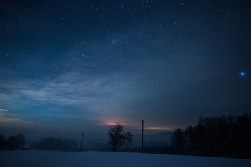 starry dark sky in carpathian mountains at night in winter