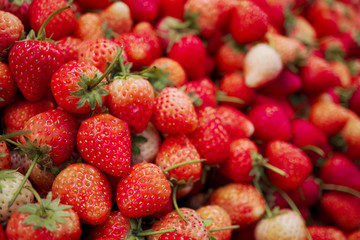 Strawberries background. Many fresh Strawberry heap for sale in market. Fruit background.