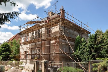 House renovation, scaffold on house.