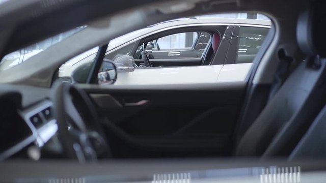Auto standing in a row at a car dealership. Car showroom.
