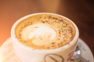 delicious Italian cappuccino with a froth on a wooden table, a great tonic drink