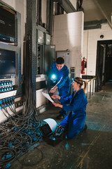 Electricians Fixing a Switch Board
