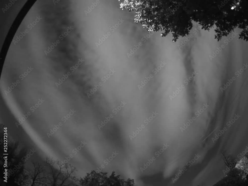 Wall mural time lapse of clouds and stars that move around the pole , taken with special mono camera.