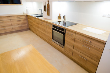 Aesthetic modern narrow kitchen with wooden furnitures