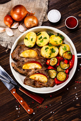 Grilled steak, boiled potatoes and vegetables