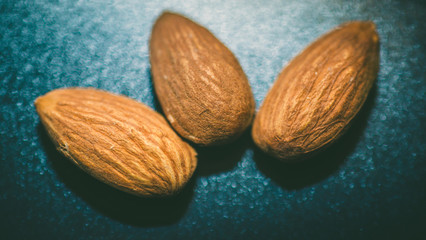 Almonds in wooden background