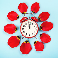 Spring forward time. Stylish vintage red alarm clock. Daylight savings time concept. Alarm clock...