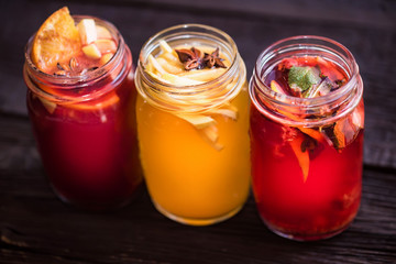 Three glass jars with delicious hot winter beverages close