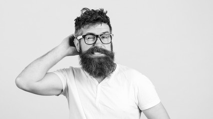 Confused bearded young man in glasses. Hipster trying to solve difficult problem. Bearded guy tries to gather with thoughts. Brutal man thinks about something on white background.