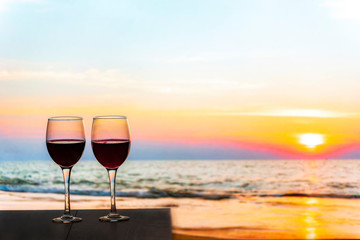 Two glasses of Red Wine Overlooking the sea during the sunset