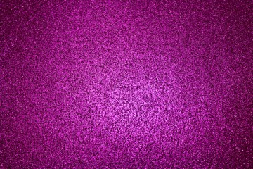Lila glitzernder Hintergrund der in der Mitte heller ist