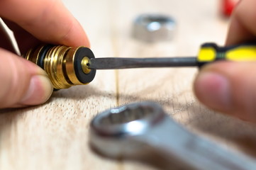 Plumber putting a gasket on a plumbing fitting, close up.
