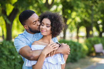 Portrait of young man kissing woman in cheek